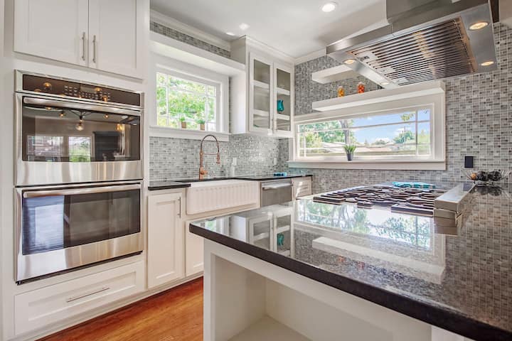 An image of a modern kitchen with sleek appliances, featuring a gas stove, refrigerator, and built-in microwave in Spring Hill